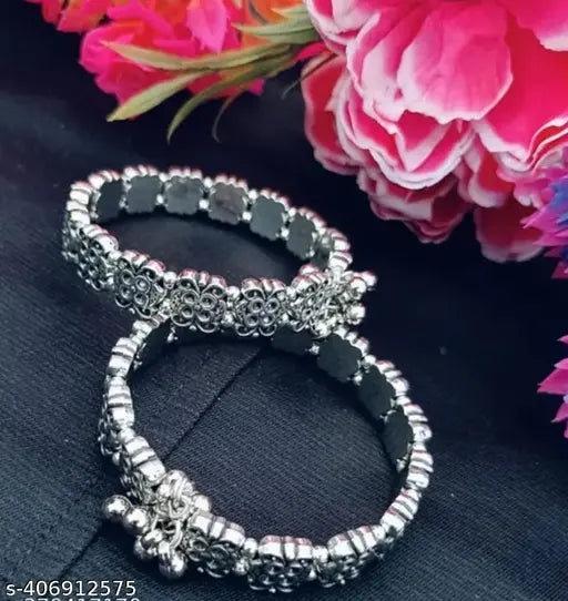 Sterling silver kada bangles for women, set of 2, showcasing shiny silver jewelry with intricate design details.