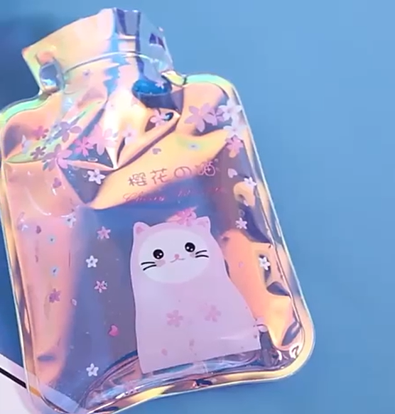 Soft hot water bag by 18075, filled with water, with a fabric cover, designed for therapeutic heat relief and comfort.