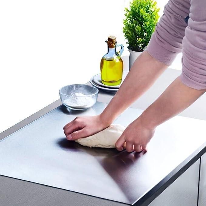 Stainless steel chopping board from 18057, measuring 35x31cm, with a smooth surface for food prep and slicing.