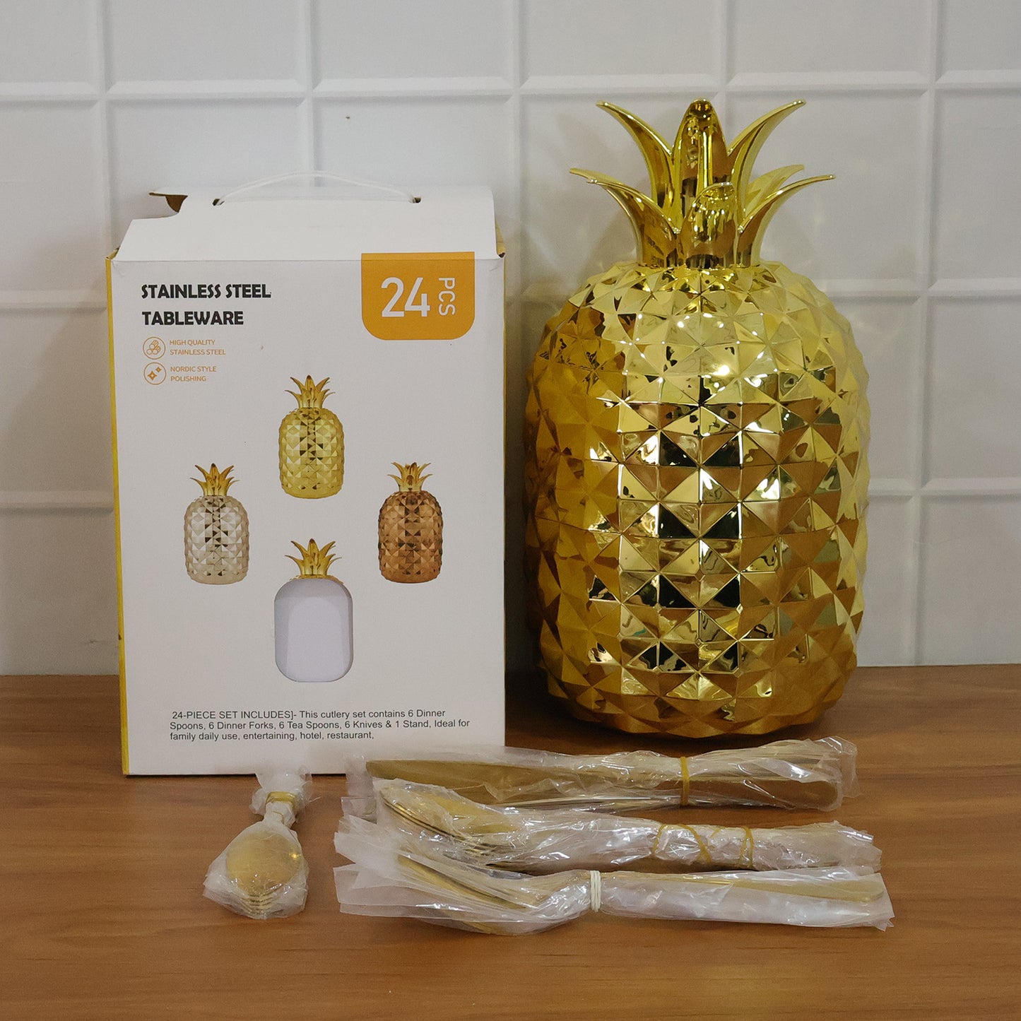 Wukusy stainless steel golden cutlery set with 24 pieces displayed on a pineapple-shaped storage stand.