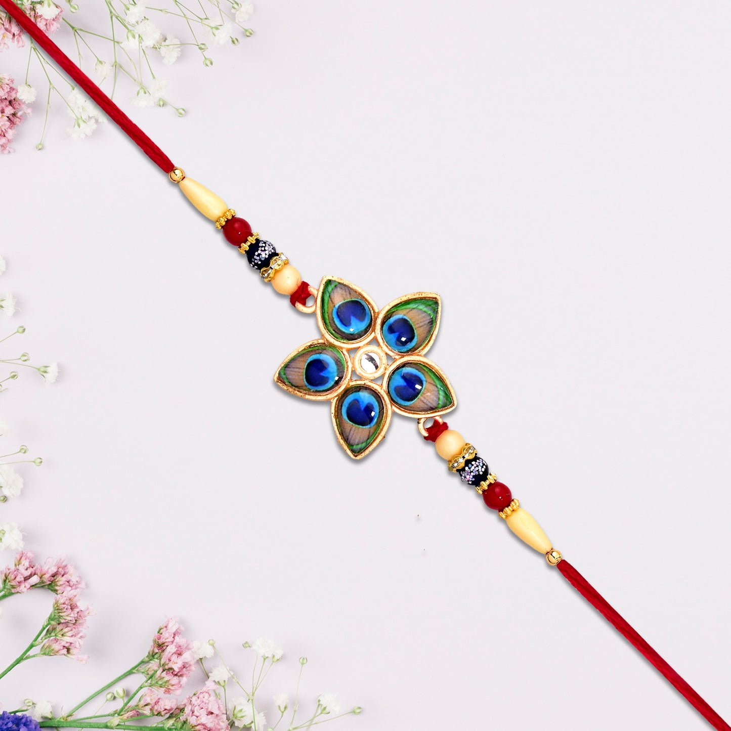 Star-shaped Designer Mor Pankh Rakhi by Wukusy, featuring intricate fashion design and detailed craftsmanship in vibrant colors.