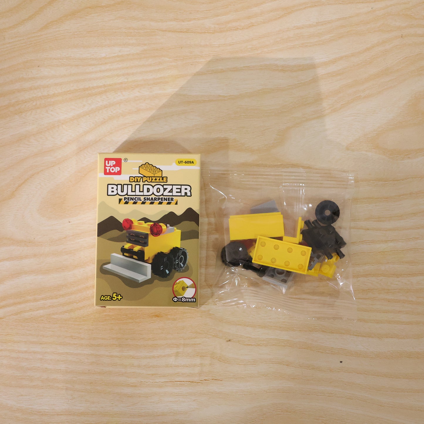 Wukusy cute bulldozer pencil sharpener toy on a desk, featuring a colorful, interactive design for fun and creativity.
