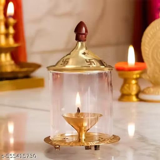 Brass and glass Akhand Deep Diya with cover for puja, traditional oil lamp for religious rituals and spiritual lighting.