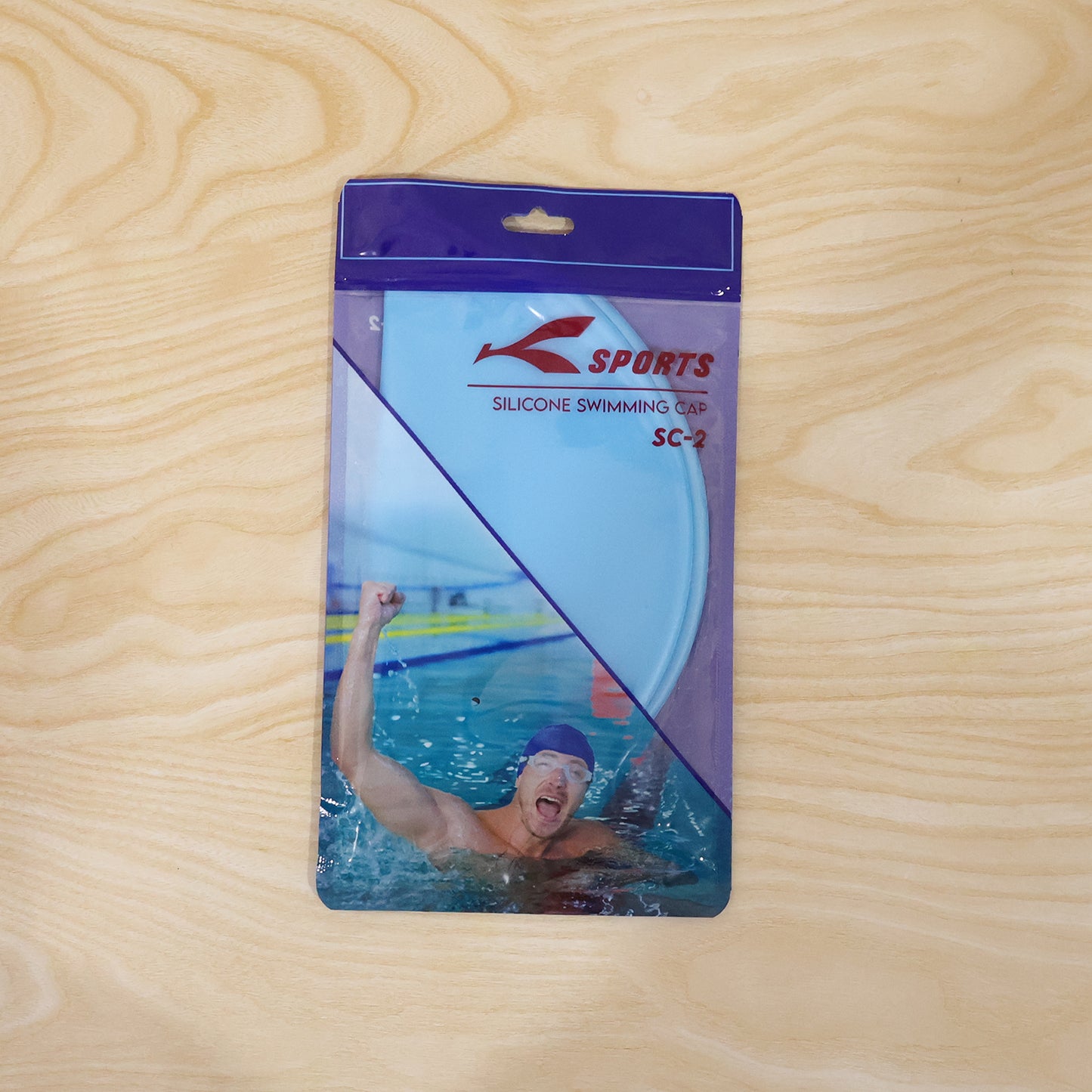 Stretchable waterproof silicone swimming cap by Wukusy, shown in bright blue, fits snugly to protect hair during swimming.