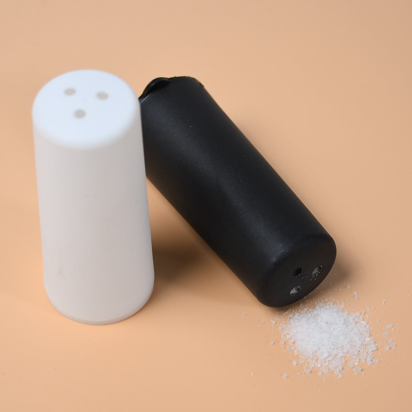 Wukusy salt and pepper dispenser set on a dining table, designed for home and hotel use for spice storage and seasoning.