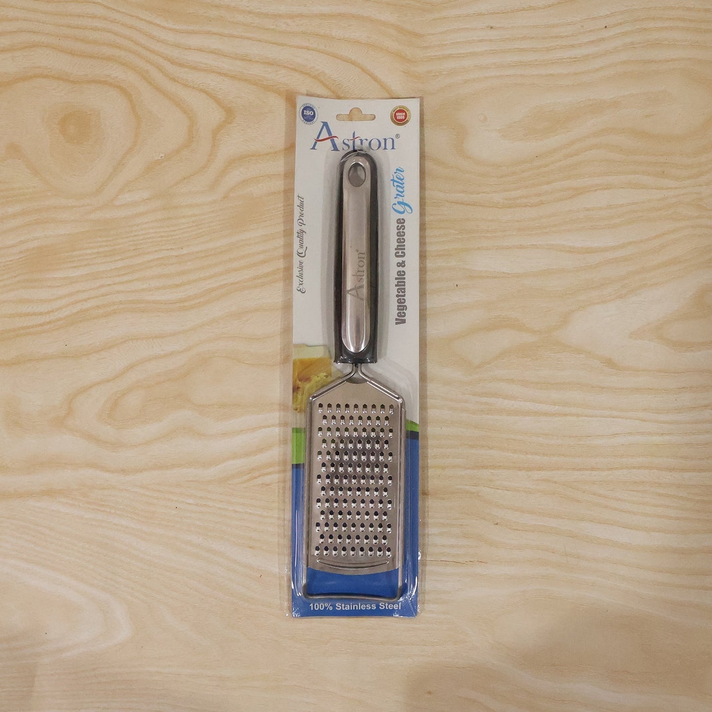 Wukusy SS slim cheese grater with plastic handle for vegetables and lemon zest, shown with grated produce on a clean surface.