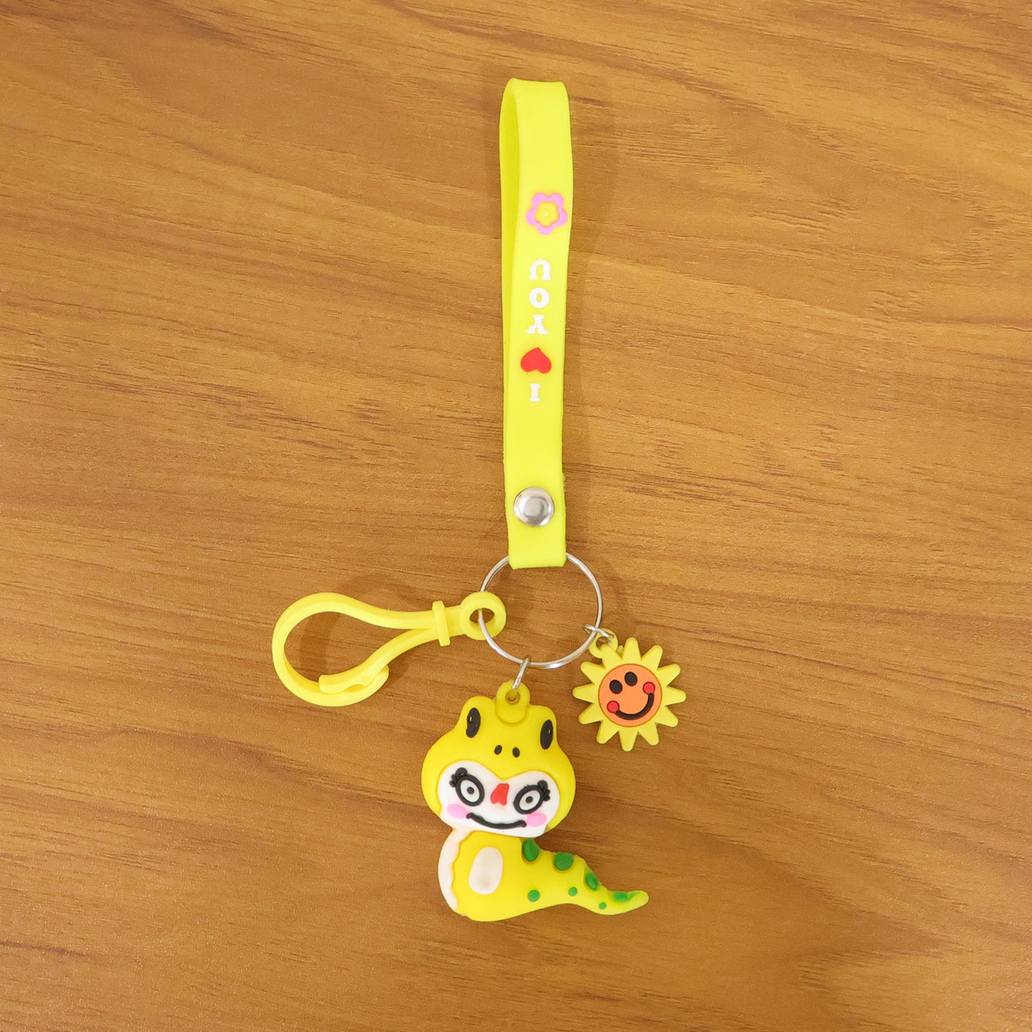 Wukusy cute cartoon dinosaur keychain with strap and decorative charm, featuring vibrant colors and playful design.