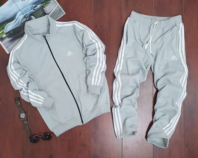 Men's Adidas grey lycra tracksuit, made of comfortable stretchy fabric, featuring a zip-up jacket and matching pants.