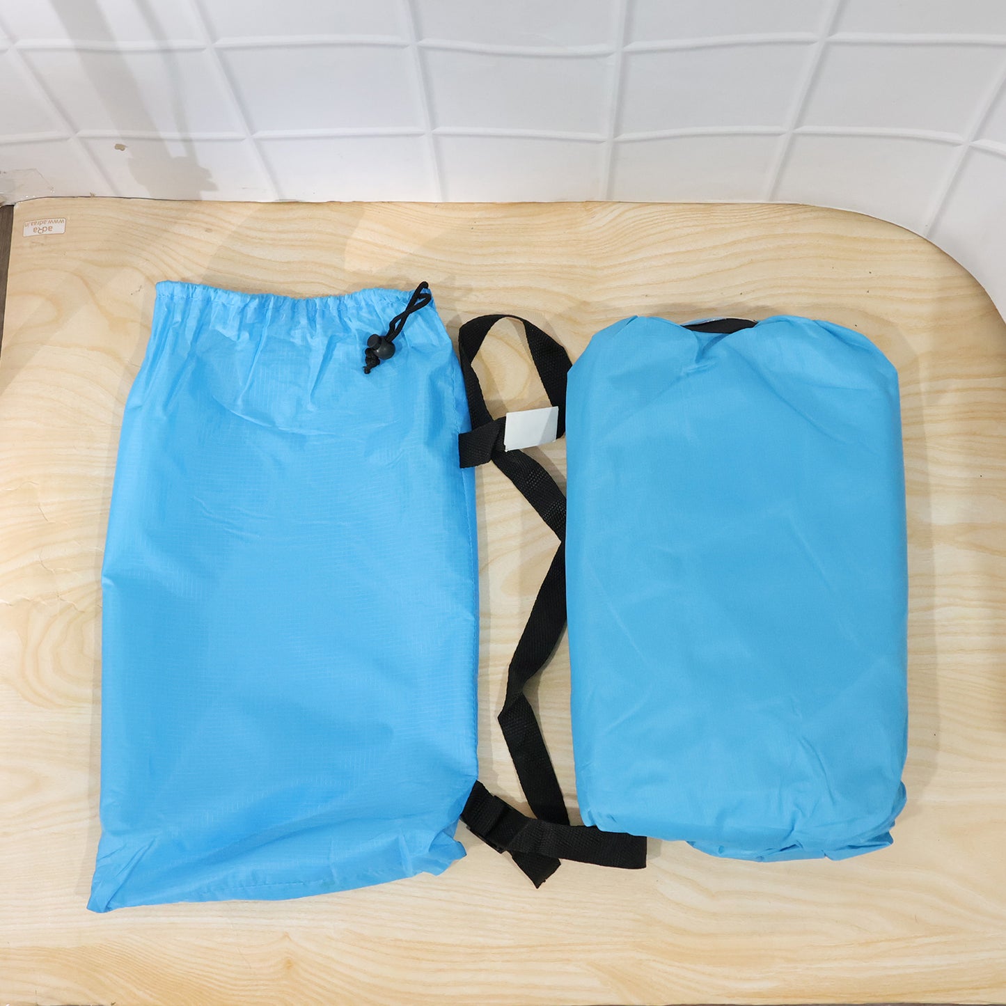 Wukusy inflatable air lounger sofa for outdoor camping, beach, or pool, showing the portable, bright-colored air sofa in an outdoor setting.