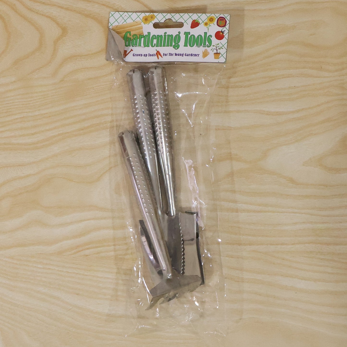 Wukusy stainless steel 3-in-1 garden hand tool set with spade, rake, and fork, displayed on a garden background.