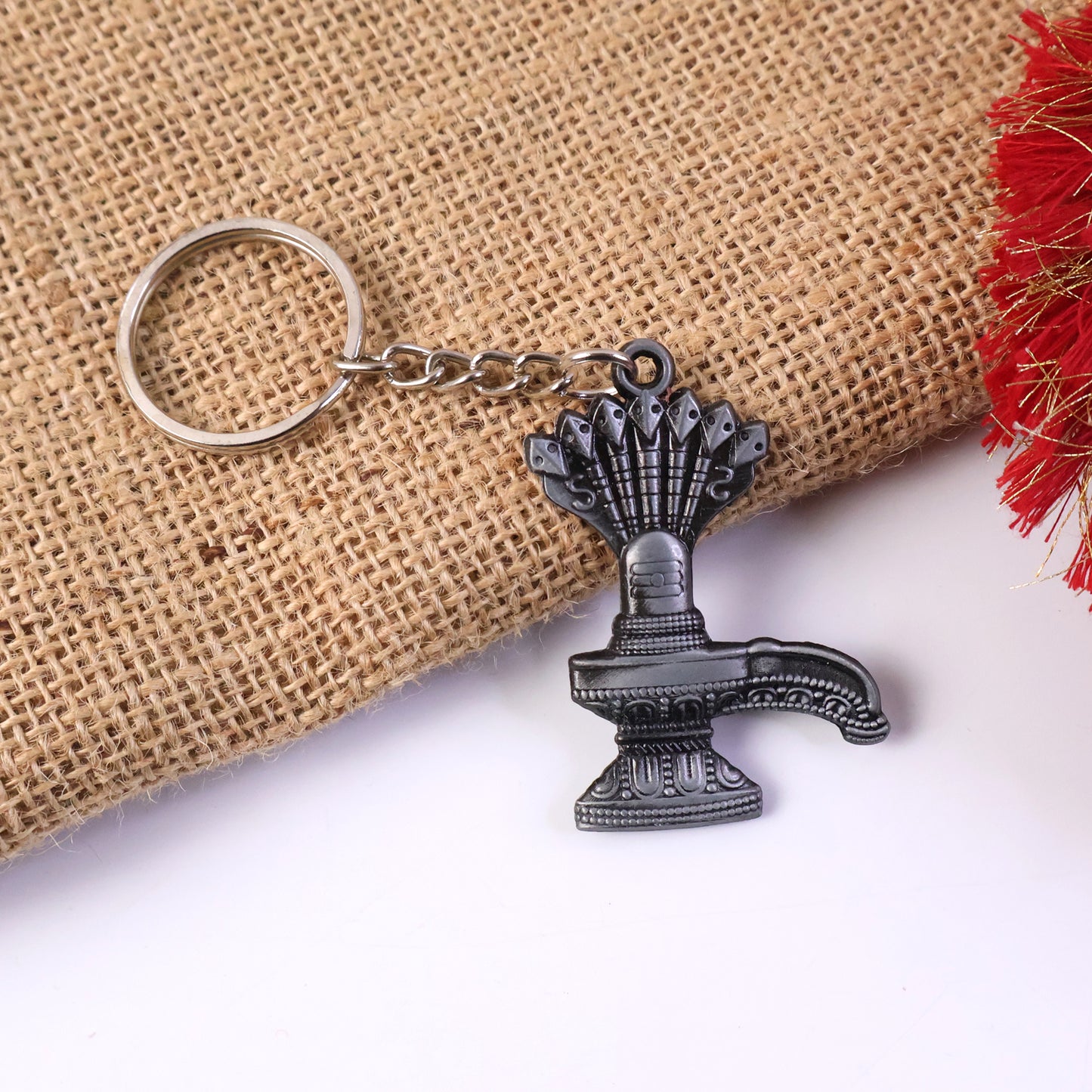 Premium metal Shiva Lingam with Naag keychain by Wukusy, featuring detailed religious design on a compact keychain.
