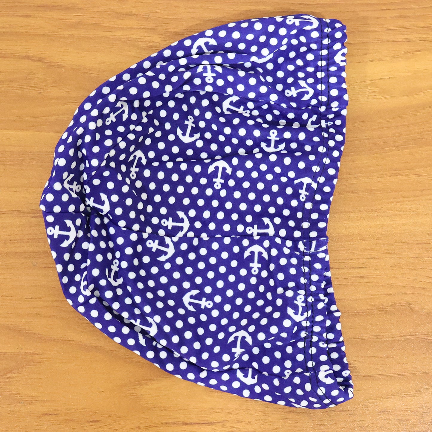Stretchable swimming cap by Wukusy, premium quality, snug fit, and durable fabric, shown on a model's head for swimming use.