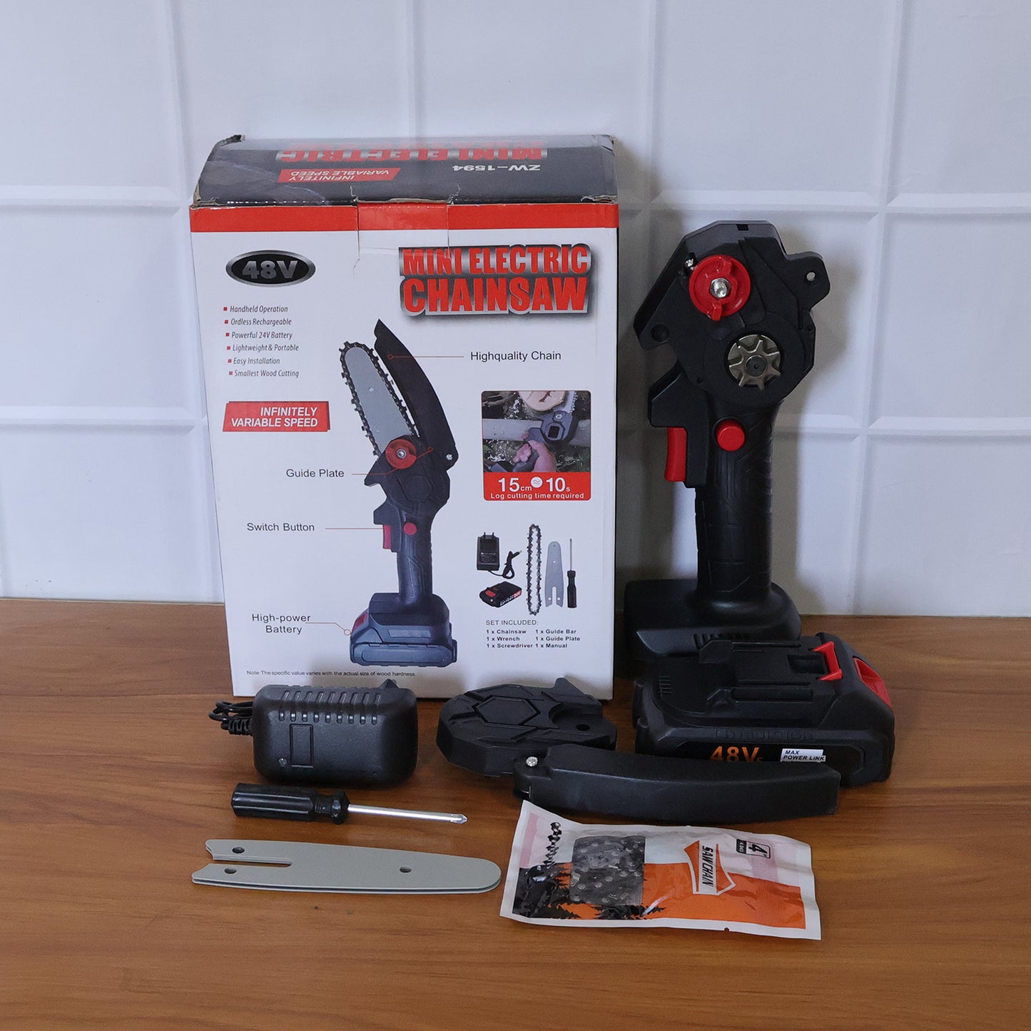 Wukusy mini electric cordless chainsaw with 24cm blade, 48V battery, compact design, and safety handle for pruning and cutting tasks.