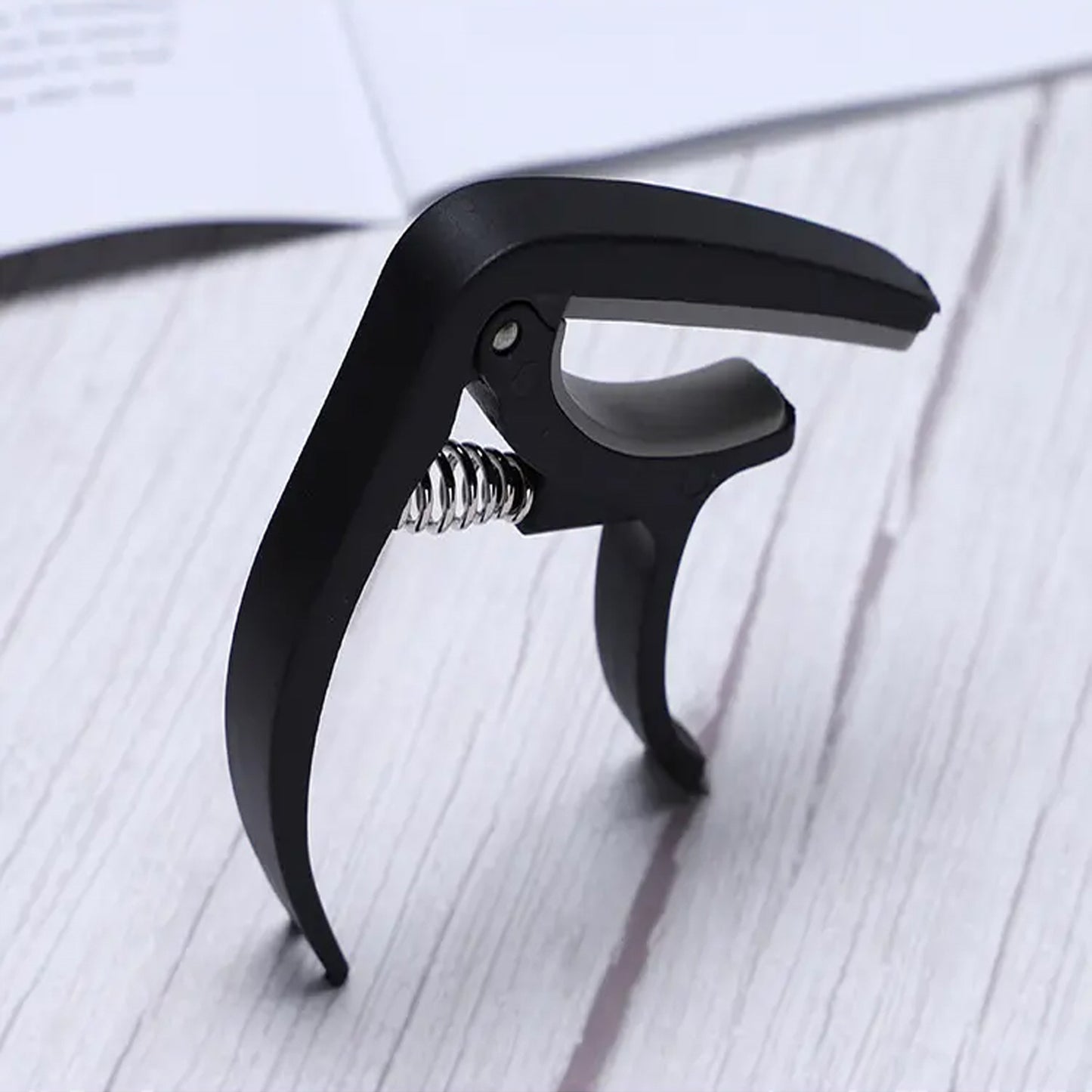 Wukusy 6141 guitar capo with pickup stand and soft pad for acoustic, electric guitar, ukulele, mandolin, and banjo accessories.