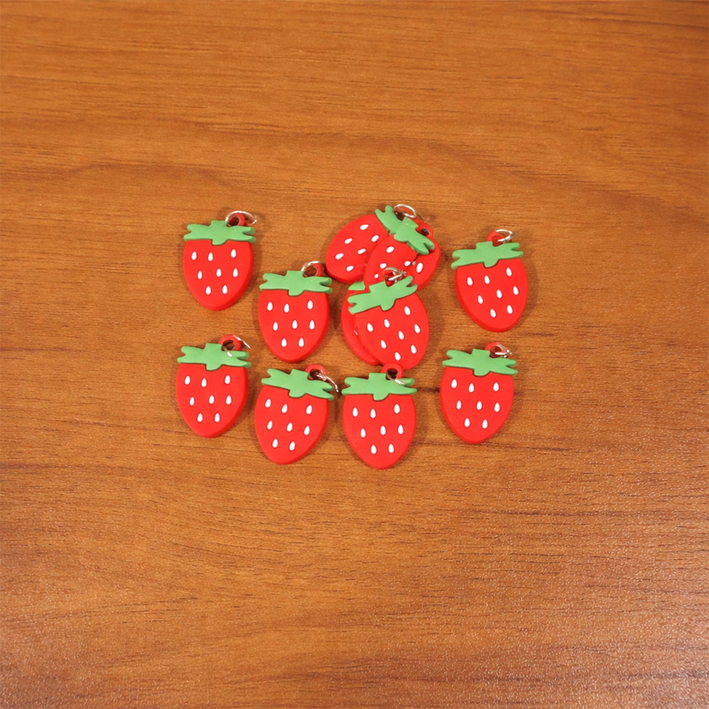 Set of 10 Wukusy strawberry design bag charm keychains with colorful, playful fruit-themed accessories for bags and keys.