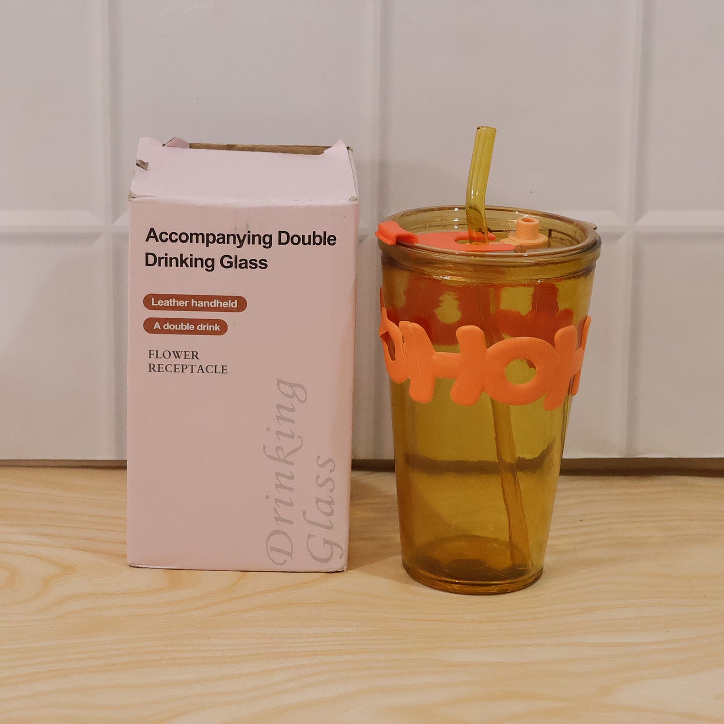 Clear glass tumbler with lid and straw, 450ml capacity, by Wukusy, showing the transparent design and included straw in the image.