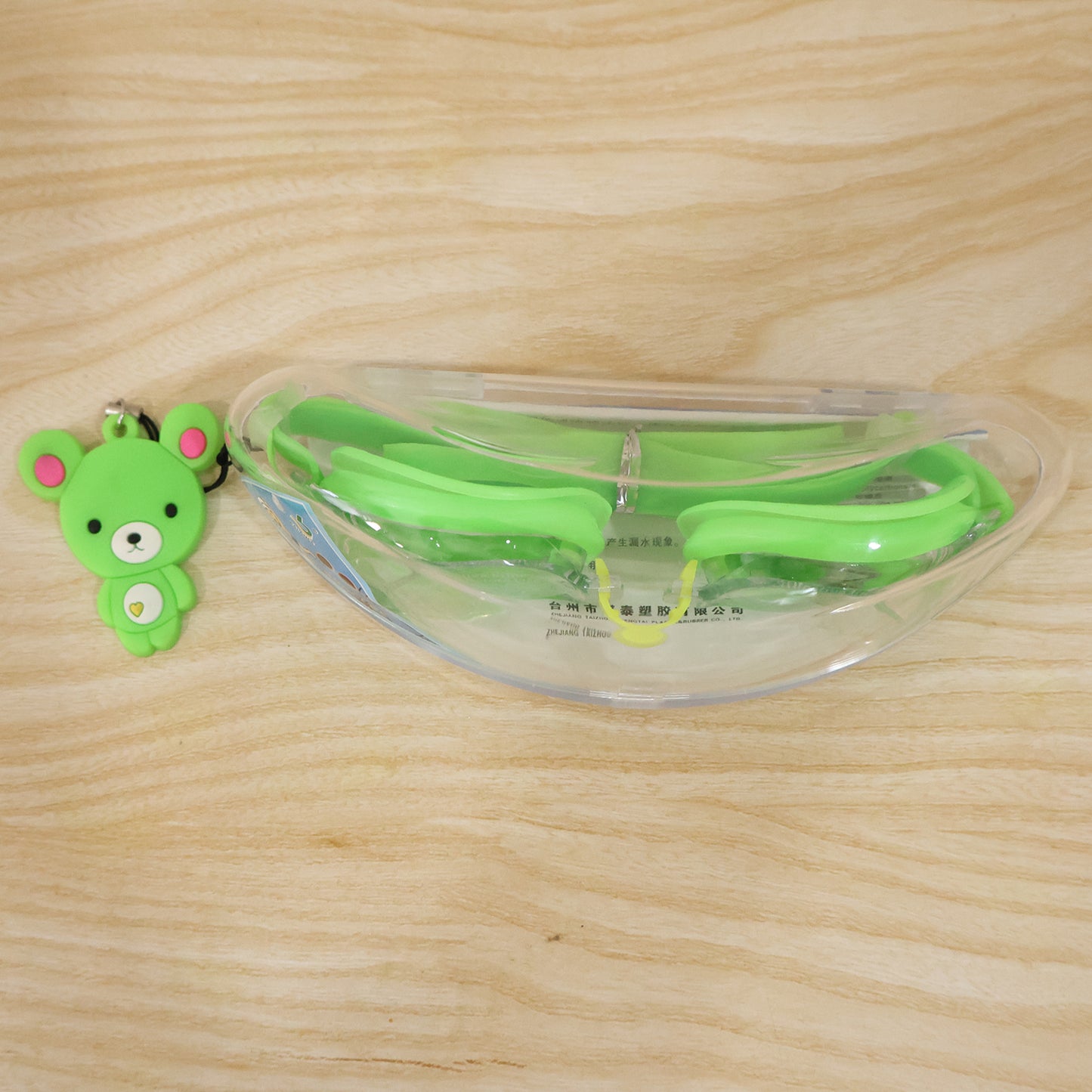 Wukusy premium swimming goggles with clear lenses and adjustable straps, stored in a protective case.