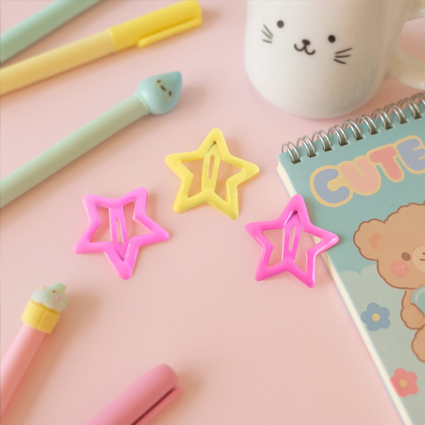 Three star-shaped hair clips for girls by Wukusy, featuring shiny gold and silver finishes in a set of three.