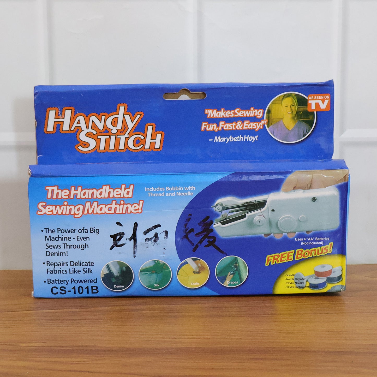 Portable Wukusy handheld sewing machine set with compact design, featuring a sewing handle, thread spool, and control buttons.