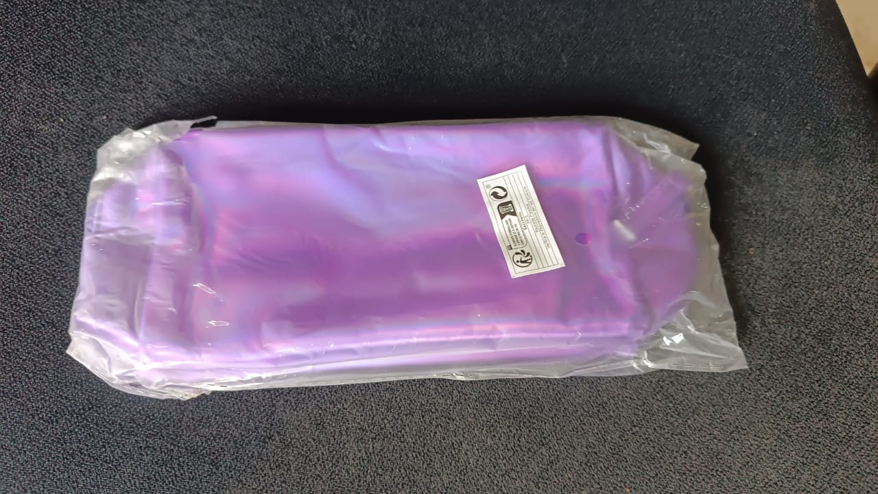 Shiny holographic waterproof travel cosmetic pouch by Wukusy, with a glossy, reflective surface and zipper closure.