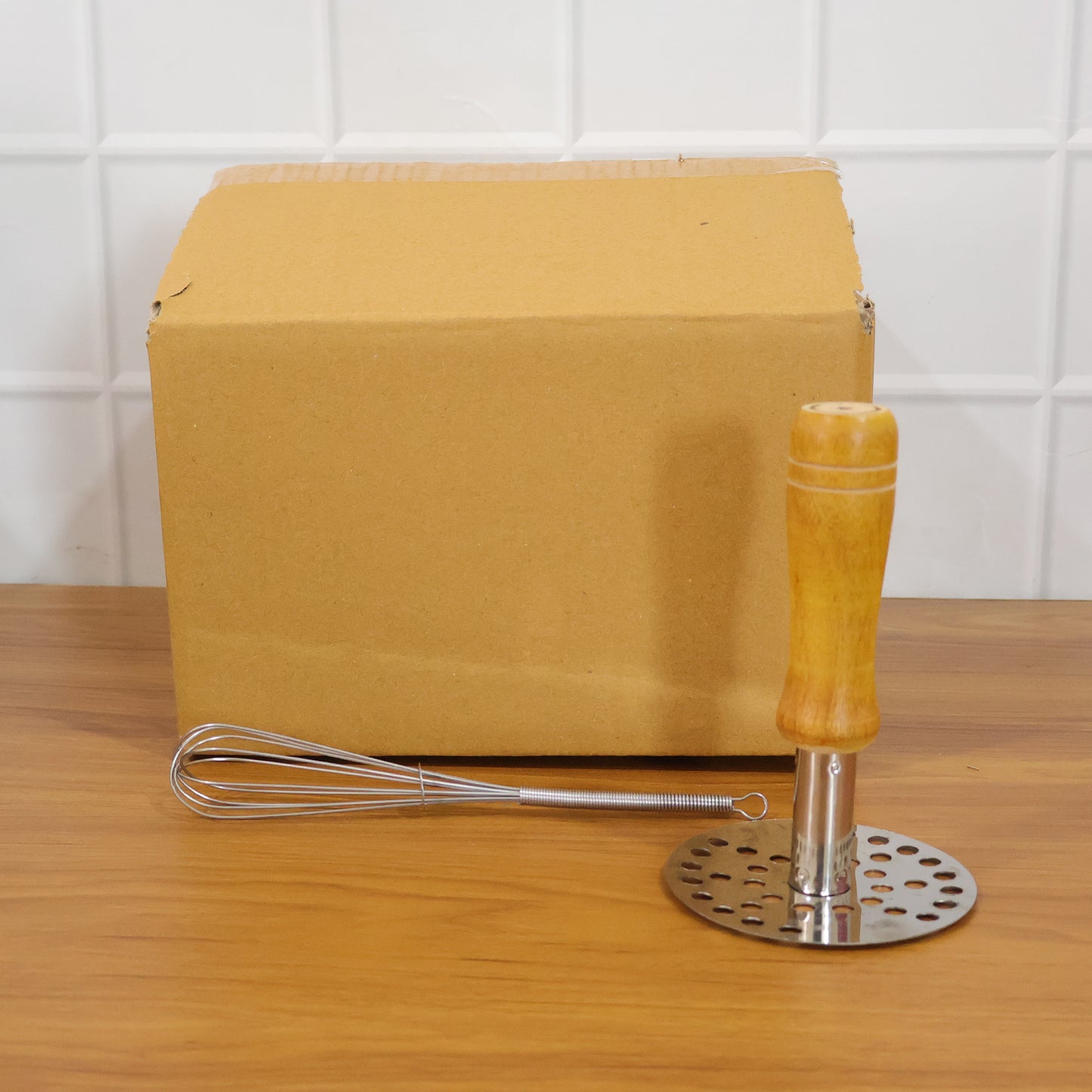 Wukusy stainless steel manual whisk and pav bhaji potato masher combo set, showing two durable kitchen utensils on a countertop.