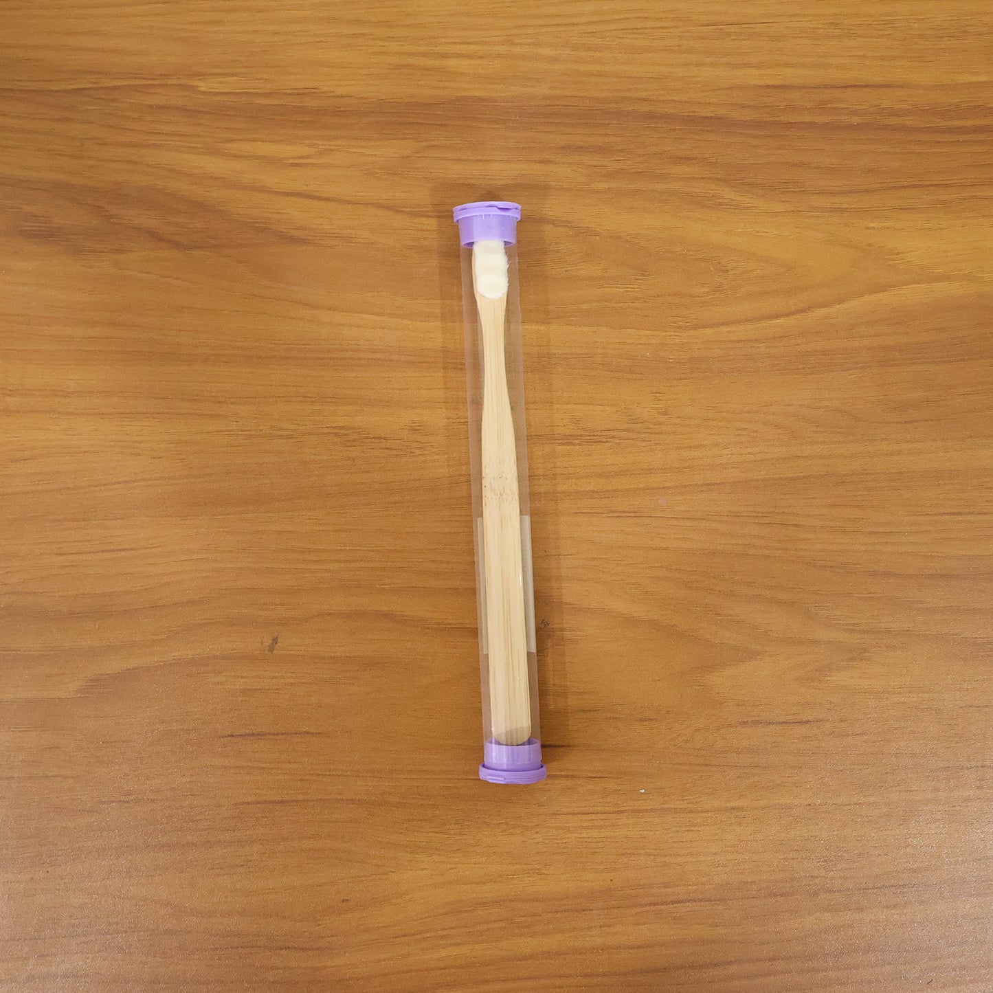 Eco-friendly wooden bamboo toothbrush with protective travel case by Wukusy, shown with natural bamboo handle and travel cover.
