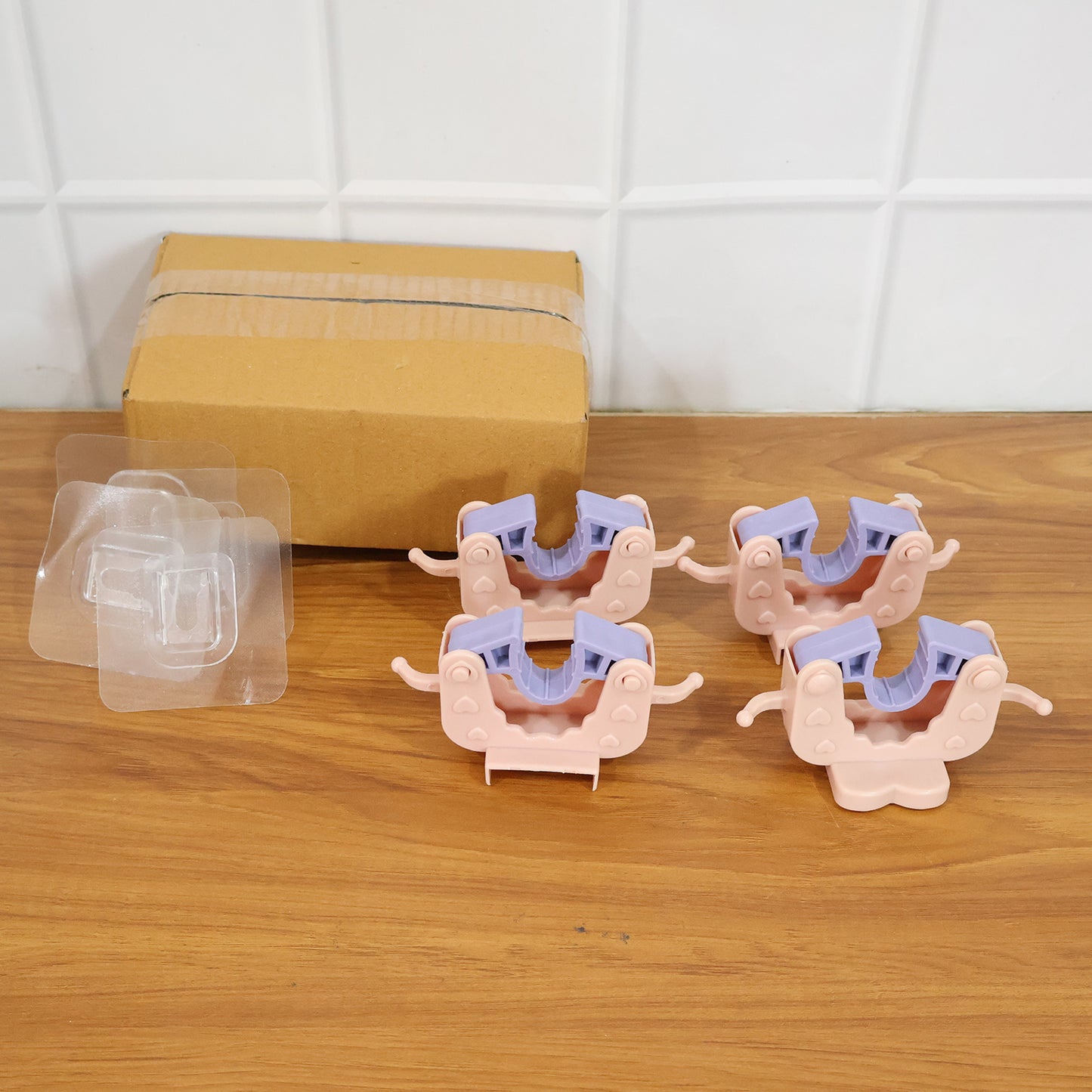 Set of four Wukusy wall-mounted broom and mop holder clips for organized storage and easy access in cleaning areas.