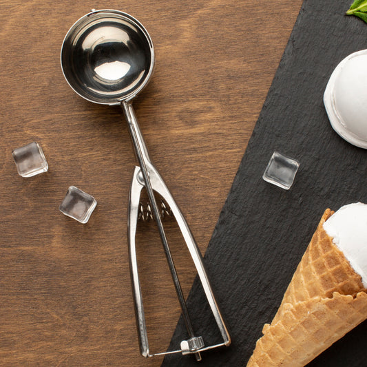Wukusy premium stainless steel ice cream scoop with trigger release and 70 ml capacity, showing the scoop's polished handle and rounded bowl.