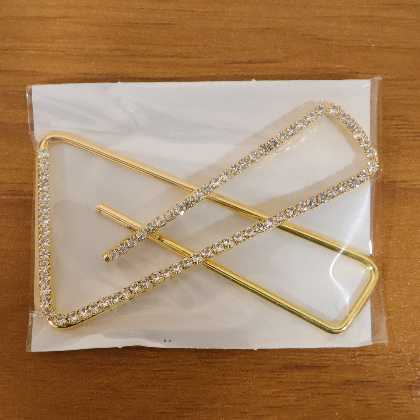 Golden crystal triangle saree safety pin brooch with intricate design, perfect for traditional Indian attire.