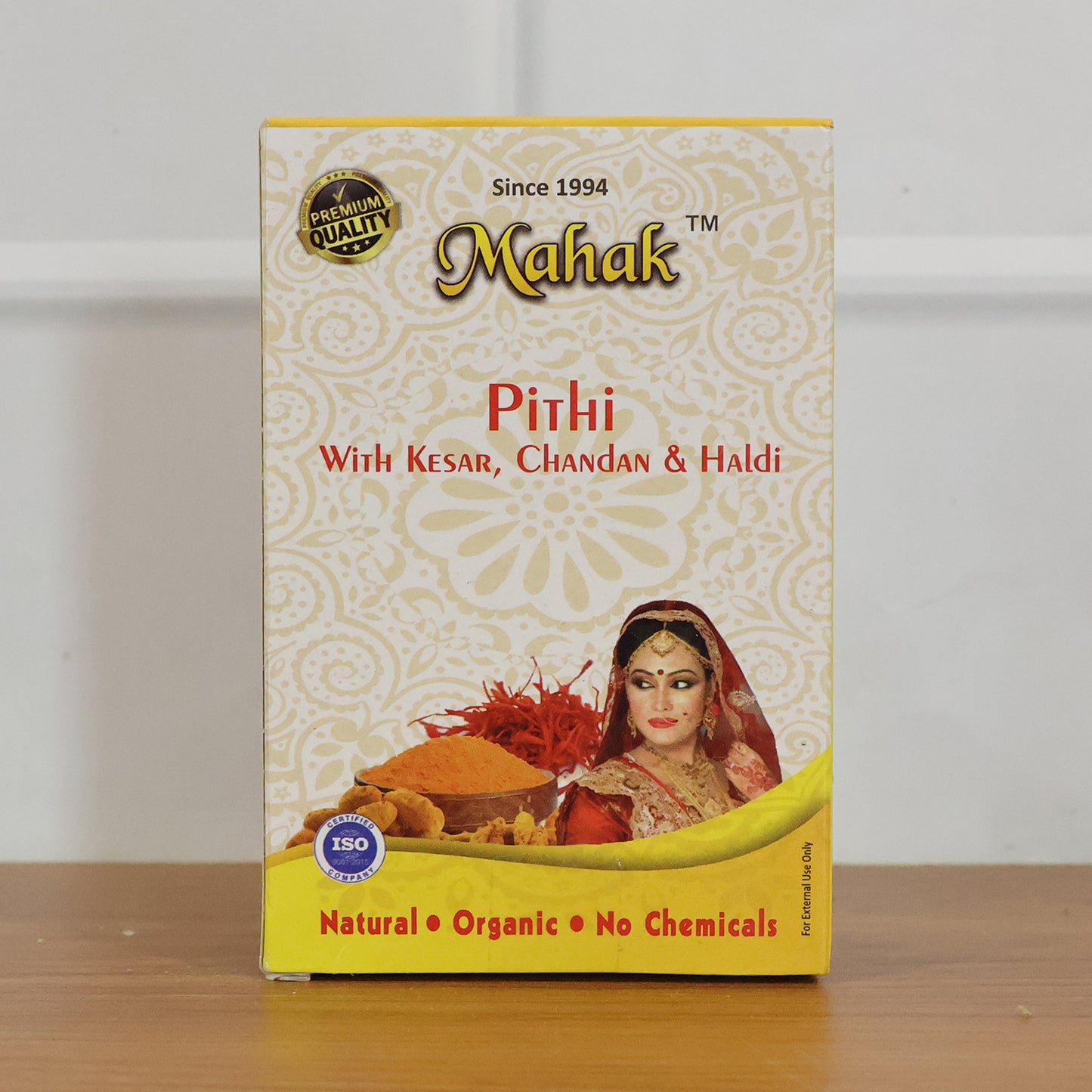 Traditional Wukusy Mahak Pithi for face and body, 100g, showing the herbal powder in a clear container with a natural backdrop.