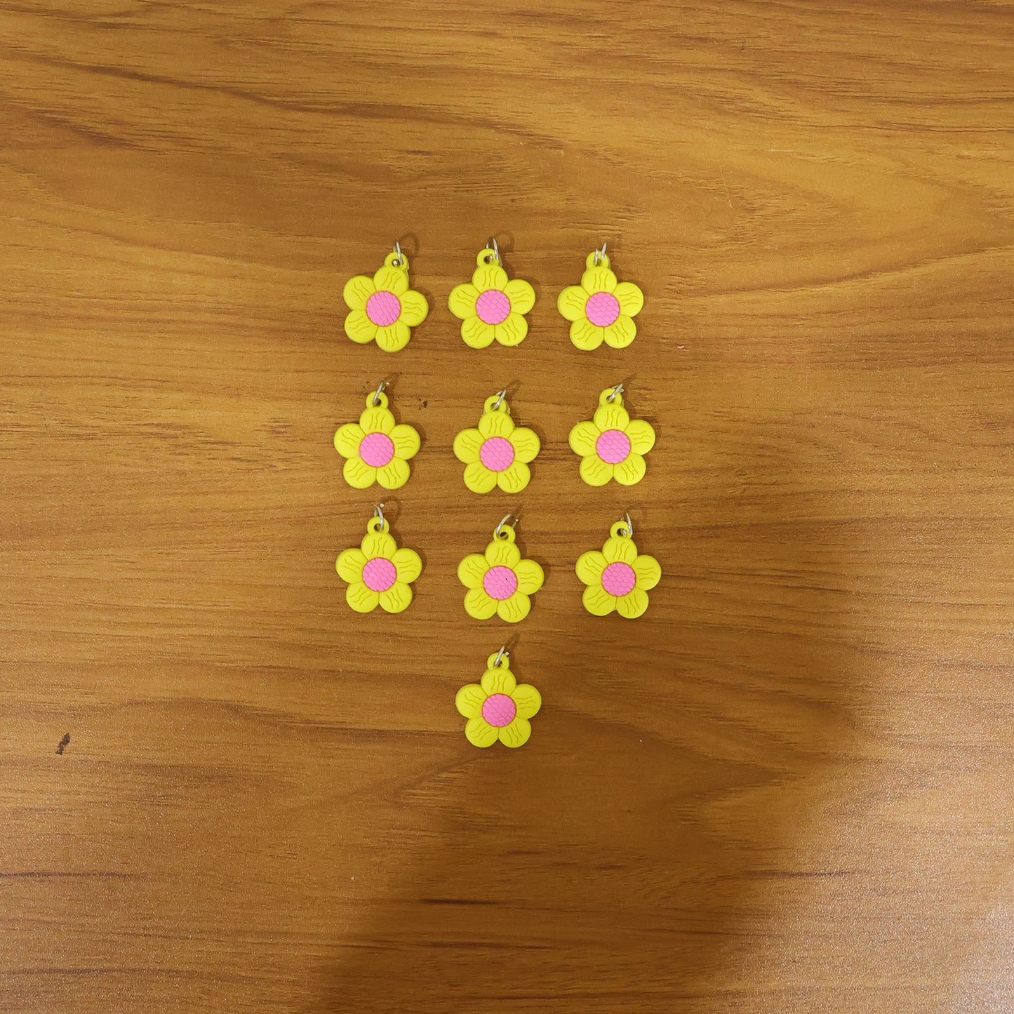 Set of 10 Wukusy cute flower shape bag charm keychains with colorful, decorative floral designs on a white background.