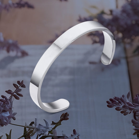 Silver-tone stainless steel open-ended kada bracelet by Wukusy, minimalist polished design for fashion wear.