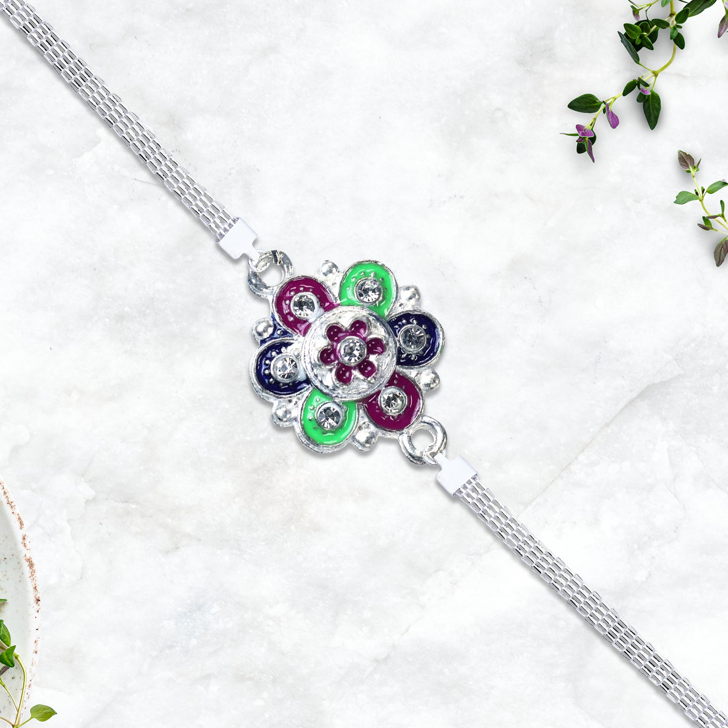 Silver flower motif Rakhi with intricate design, featuring elegant floral details, crafted by Wukusy.