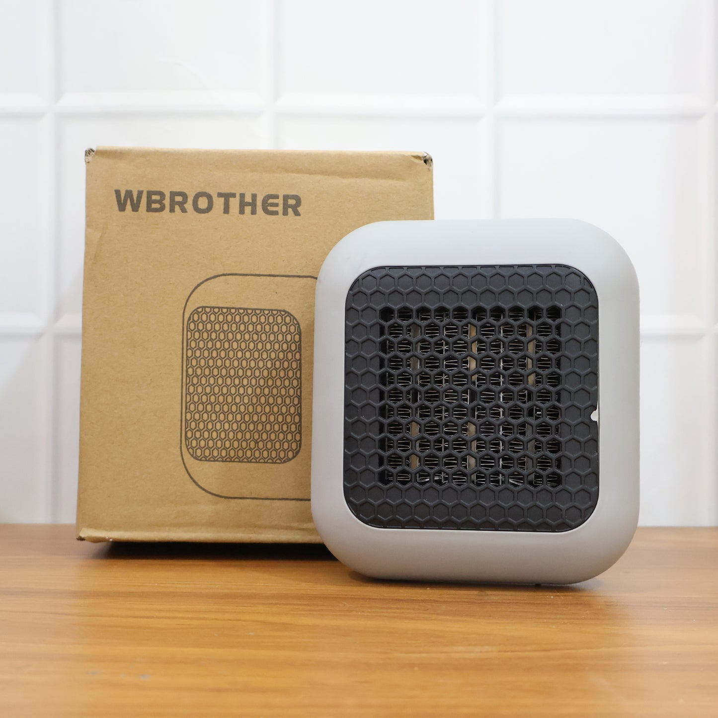 Wukusy 600W wall-mounted plug-in room heater for office, with converter, mounted on wall showing vent and power cord.