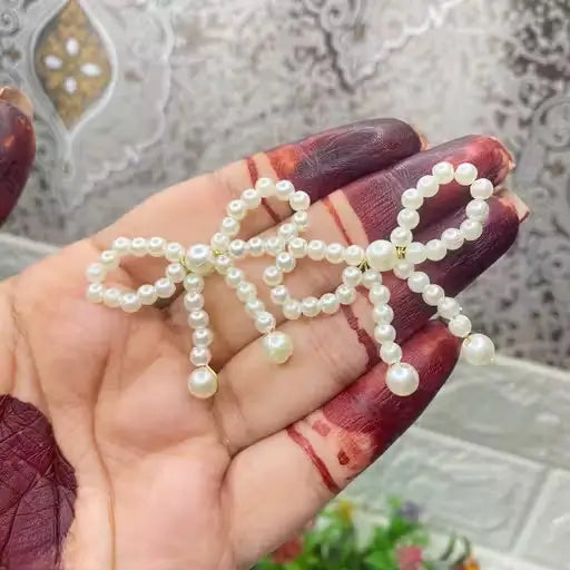 Ekom Pearl Knot Bow Dangle Earrings featuring elegant pearl accents and jewelry design, showcasing a delicate bow and dangling style.