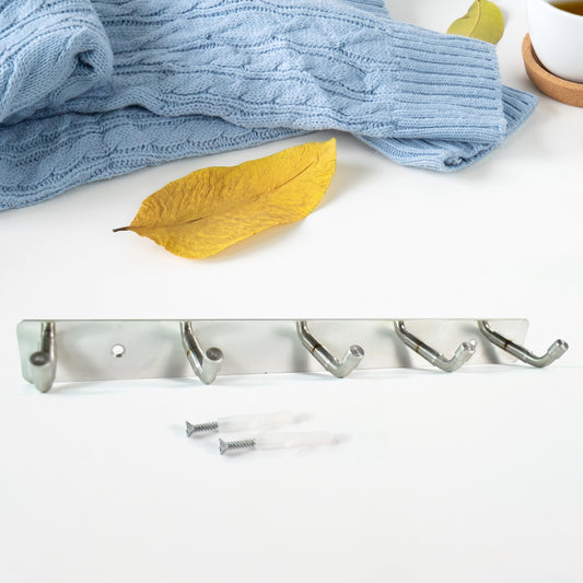 Stainless steel wall-mounted coat rack with five hooks, 26 inches long, in a modern home and kitchen setting by Wukusy.