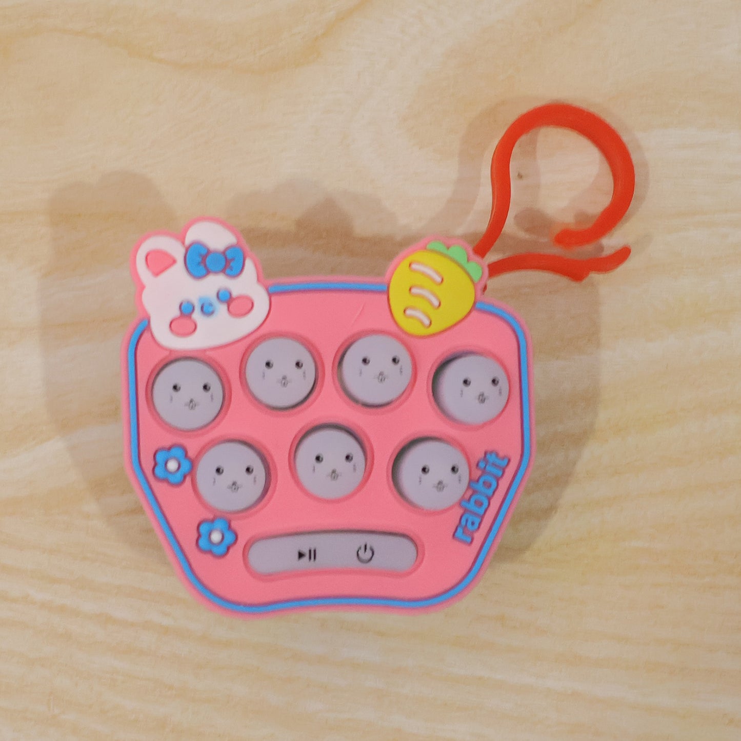Wukusy cute cartoon music push button toy keychain with sound, featuring a colorful, playful design on a keyring.