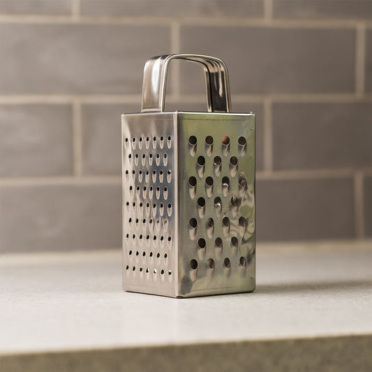 Wukusy Supermom Premium 4-in-1 stainless steel grater and slicer for kitchen use, compact design with multiple grating and slicing options.