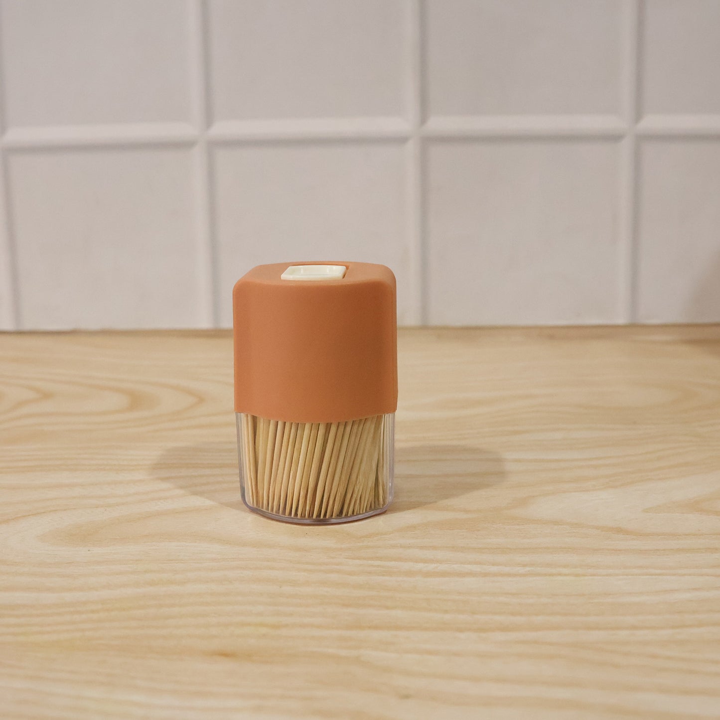Wukusy toothpick dispenser box set with automatic pop-up holder on a dining table, sleek design for convenient toothpick access.