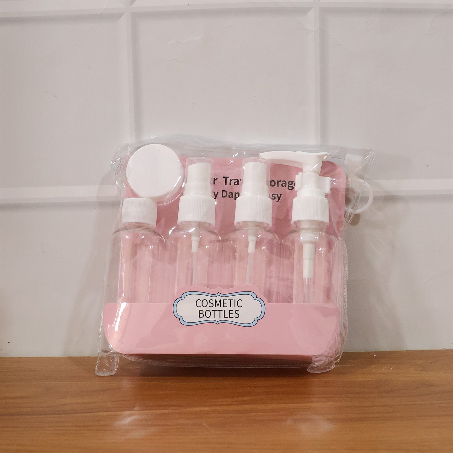Wukusy 5-in-1 refillable travel cosmetic bottle set with clear containers and pump dispensers for toiletries and skincare products.