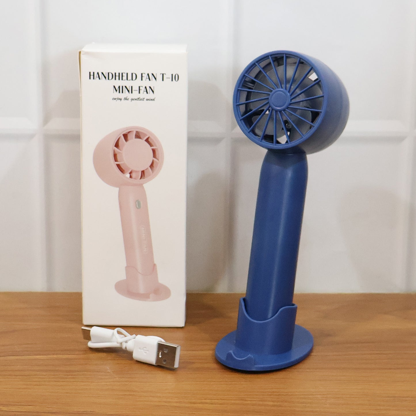 Wukusy rechargeable mini handheld fan with black body, compact design, and adjustable fan blades for personal cooling.