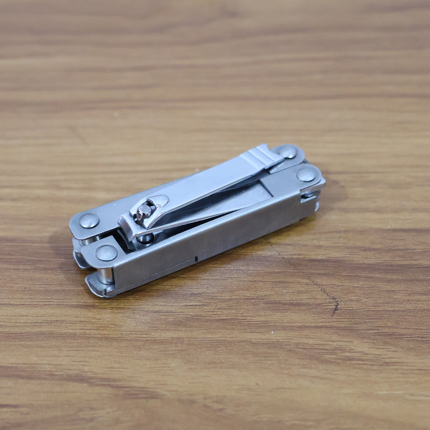 Stainless steel Wukusy 8-in-1 multipurpose pocket tool kit with various health and beauty tools, compact and portable.