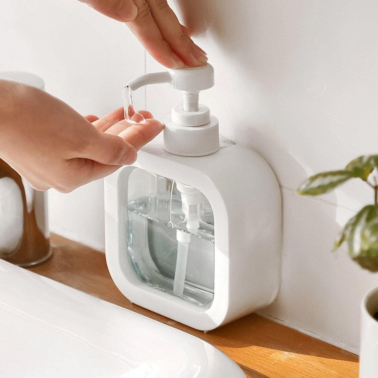 Clear plastic Snap Sink Dispenser with pump, empty lotion bottles by Wukusy for home and kitchen use.