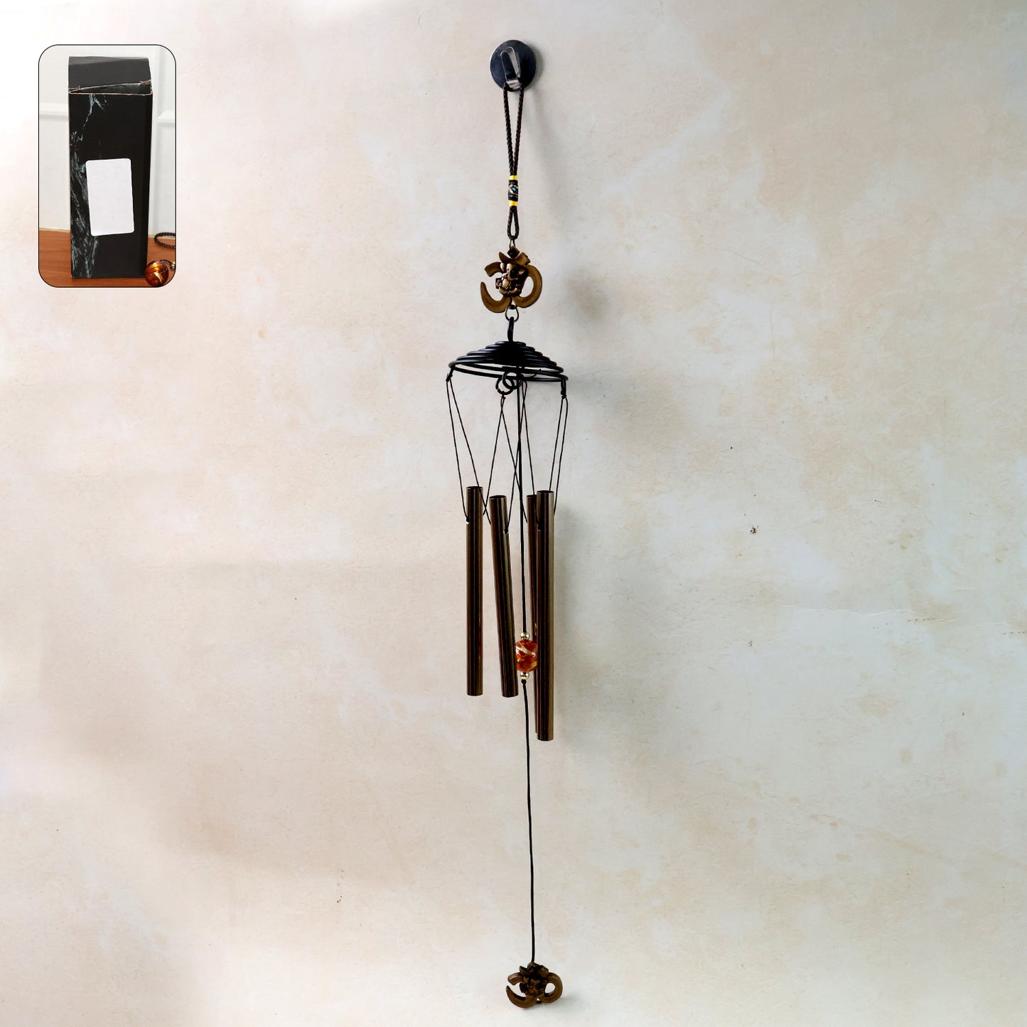 Metal wind chime with Om symbol by Wukusy, featuring hanging metal tubes and decorative Om design for peaceful outdoor decor.