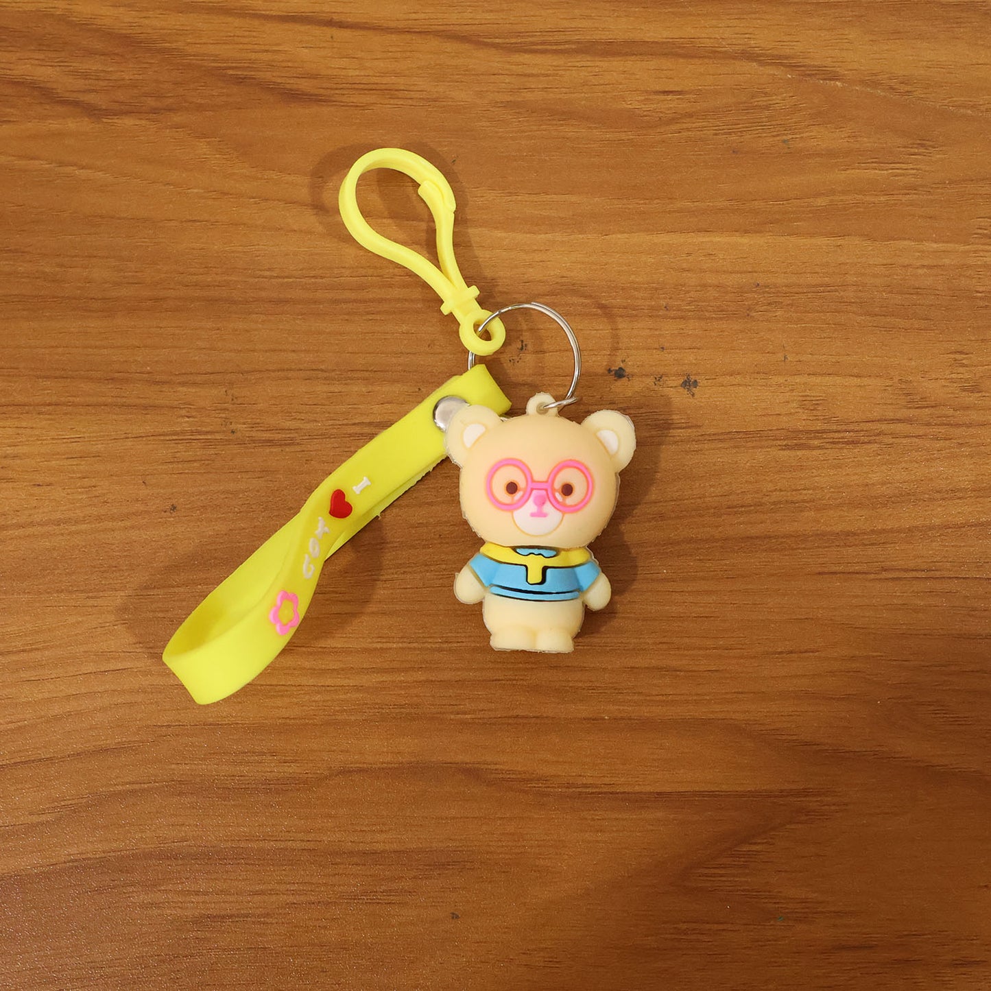 Cute cartoon bear silicone keychain by Wukusy, featuring a colorful bear design on a keyring.