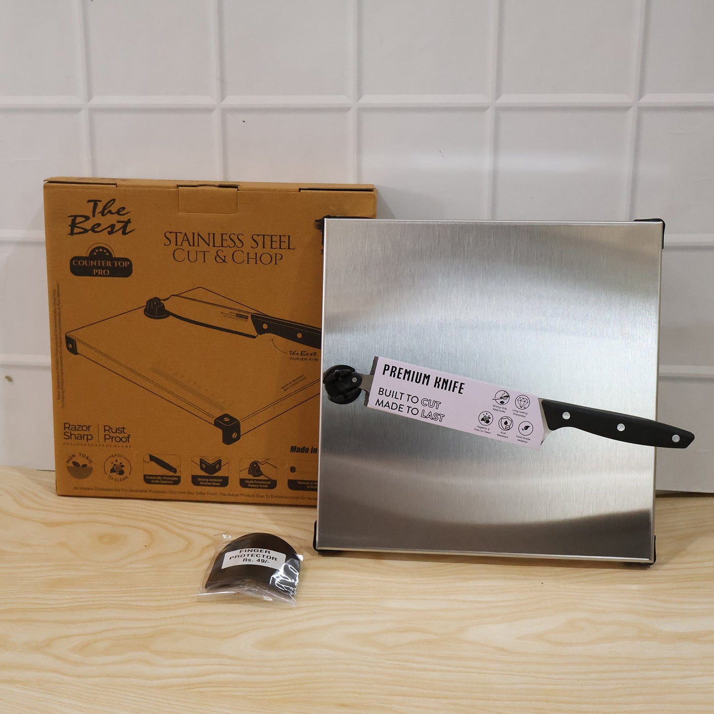 Wukusy stainless steel 2-in-1 cutting and chopping board with built-in knife, shown with knife and chopping surface.