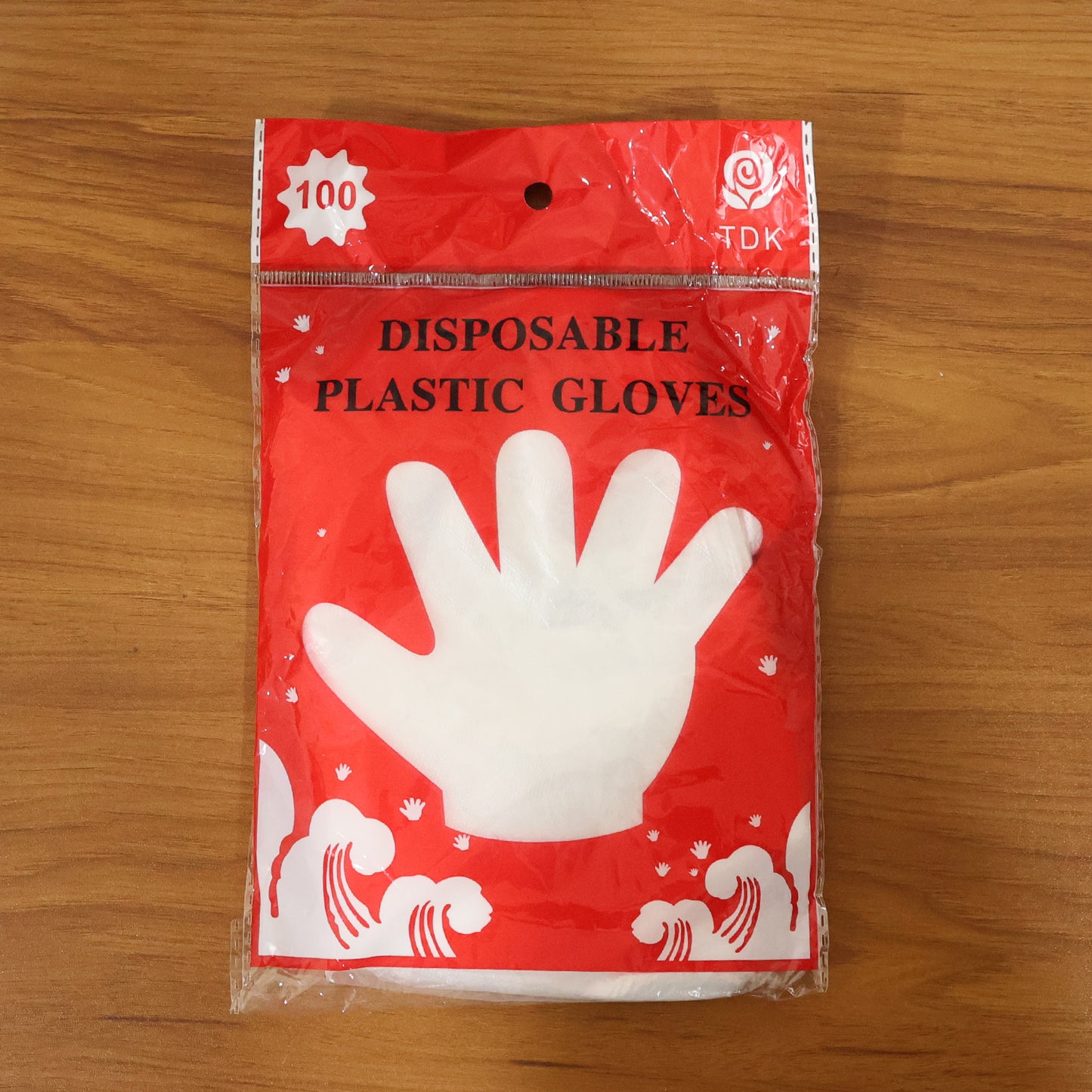 Disposable transparent plastic gloves from Wukusy, 100-piece pack, showing clear, flexible gloves suitable for various tasks.