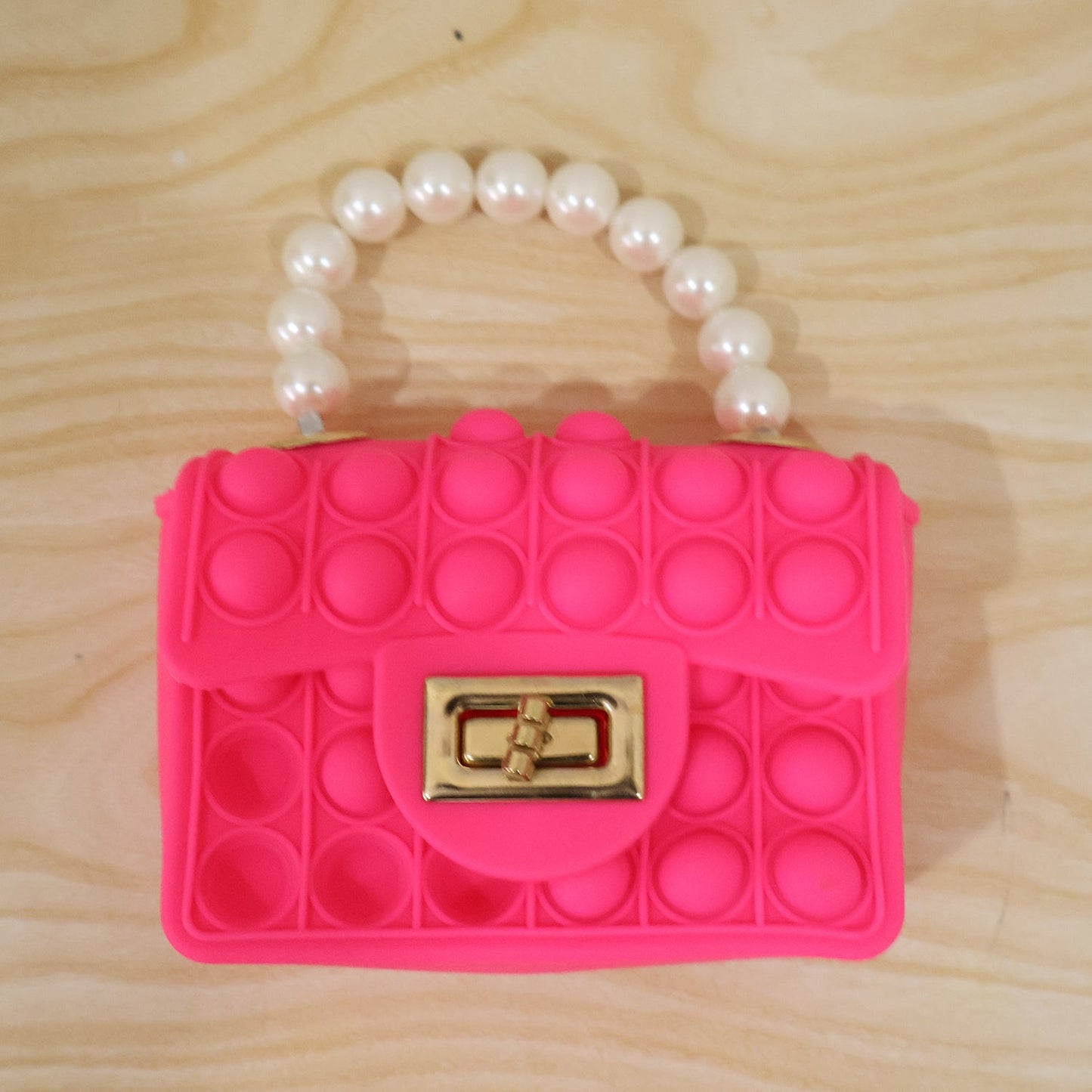 Kids Pop It fidget purse with silicone sling bag and pearl handle, colorful and playful, by Wukusy.