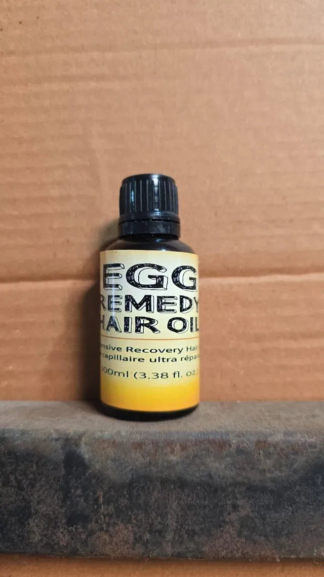 Baby hair oil by 18058, Egg Remedy Hair Oil 100ml, showing the bottle with natural ingredients inside, designed for gentle baby hair care.