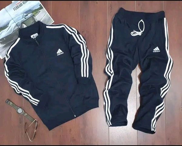 Navy blue Adidas men's tracksuit made of lycra, featuring a fitted athletic design with the brand logo on the chest.